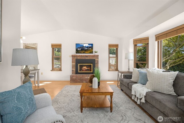 8833 47th Pl W, Mukilteo, WA 98275 - living room featuring lofted ceiling, a brick fireplace, and light wood-type flooring