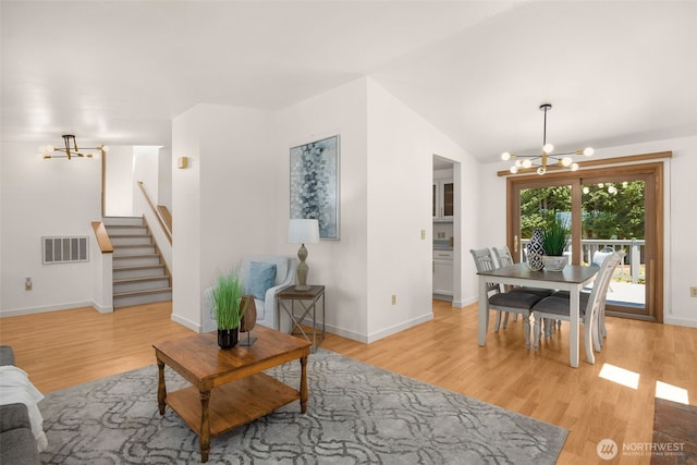 8833 47th Pl W, Mukilteo, WA 98275 - living area with a chandelier, light wood-style floors, stairway, and vaulted ceiling