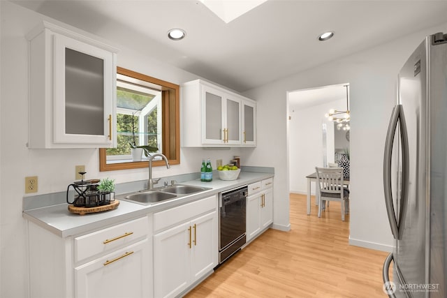 8833 47th Pl W, Mukilteo, WA 98275 - kitchen with freestanding refrigerator, dishwasher, light countertops, light wood-style flooring, and white cabinetry