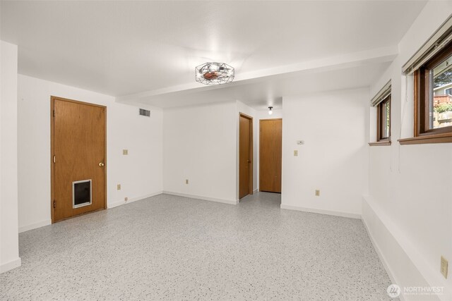 8833 47th Pl W, Mukilteo, WA 98275 - unfurnished room with baseboards and dark aggregate flooring