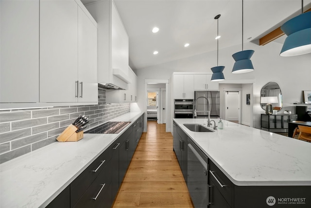 451S Partridge Ln, East Wenatchee, WA 98802 - kitchen featuring stainless steel appliances, dark cabinetry, modern cabinets, light wood-style floors, and lofted ceiling