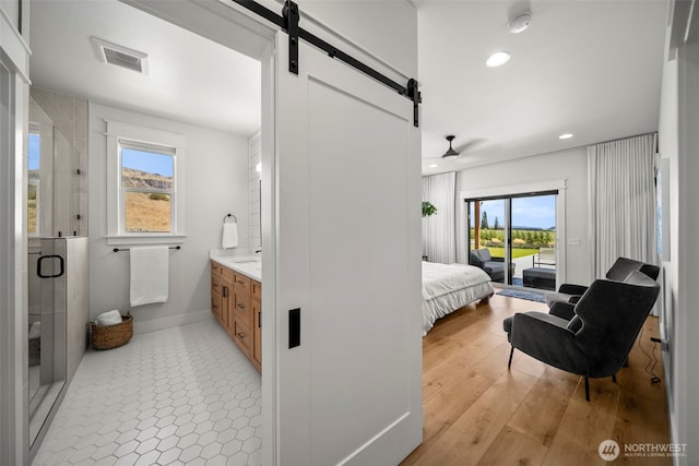 451S Partridge Ln, East Wenatchee, WA 98802 - bedroom featuring a barn door, access to exterior, and recessed lighting