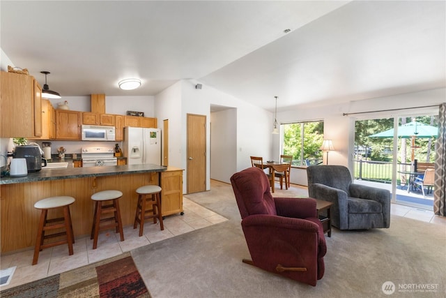81 E Dunoon Pl, Shelton, WA 98584 - kitchen featuring light tile patterned floors, a peninsula, white appliances, vaulted ceiling, and dark countertops