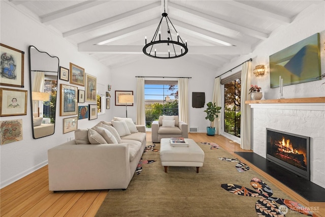 4315 52nd Ave NE, Seattle, WA 98105 - living room featuring wood finished floors, a chandelier, and a stone fireplace