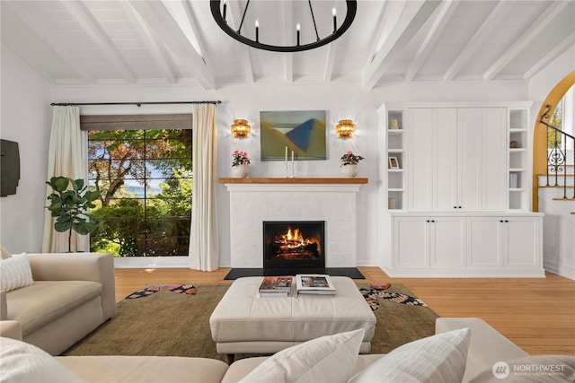 4315 52nd Ave NE, Seattle, WA 98105 - living area featuring light wood-type flooring, a fireplace with flush hearth, and a chandelier