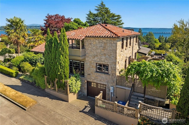 4315 52nd Ave NE, Seattle, WA 98105 - view of property featuring an attached garage, a water view, and driveway