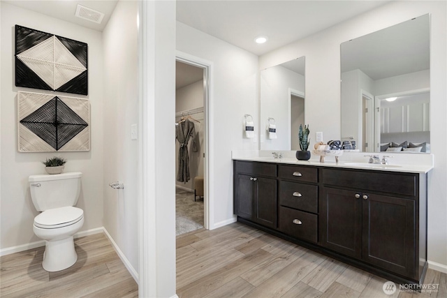 14014 198th St E, Graham, WA 98338 - bathroom with wood finished floors, double vanity, and a spacious closet