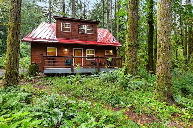 7493 Miller Way, Deming, WA 98244 - view of front of house with a standing seam roof, a metal roof, a porch, and a forest view