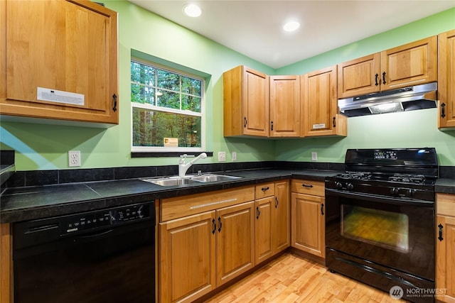 7493 Miller Way, Deming, WA 98244 - kitchen with black appliances, under cabinet range hood, dark countertops, light wood-style floors, and recessed lighting