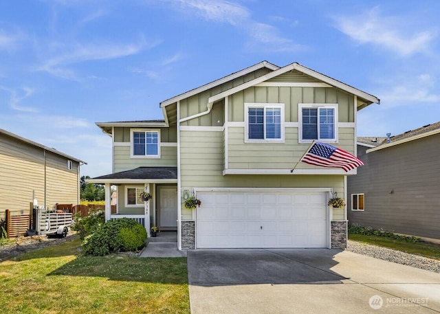 7308 Clamdigger Dr, Blaine, WA 98230 - view of front facade featuring board and batten siding, stone siding, a garage, and driveway
