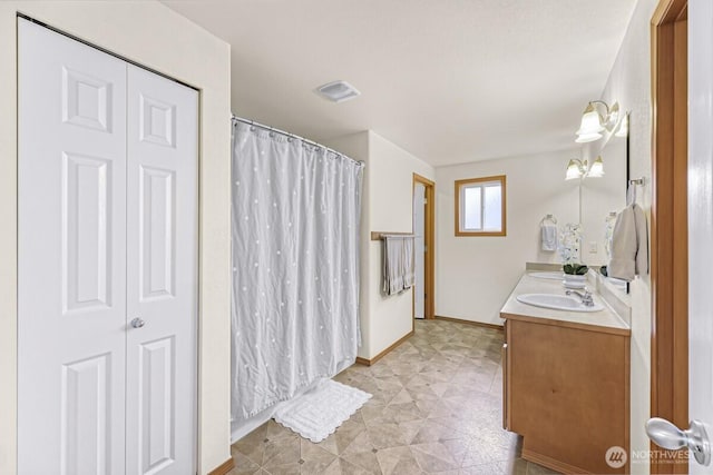 7308 Clamdigger Dr, Blaine, WA 98230 - bathroom featuring double vanity, curtained shower, and a closet