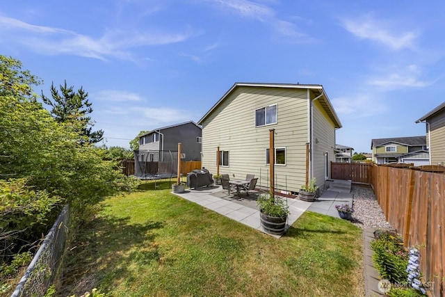 7308 Clamdigger Dr, Blaine, WA 98230 - back of property featuring a trampoline, a patio, and a fenced backyard