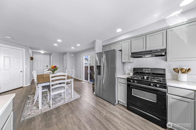 7308 Clamdigger Dr, Blaine, WA 98230 - kitchen featuring black gas stove, stainless steel refrigerator with ice dispenser, under cabinet range hood, gray cabinets, and light countertops