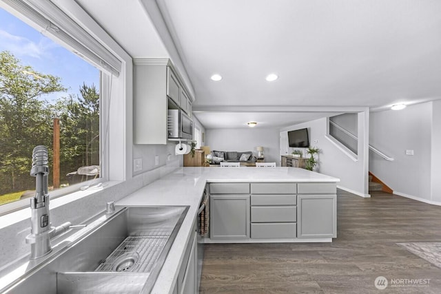 7308 Clamdigger Dr, Blaine, WA 98230 - kitchen featuring gray cabinets, a peninsula, dark wood-type flooring, light countertops, and recessed lighting