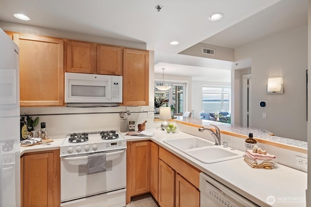 2801 1st Ave Unit 501, Seattle, WA 98121 - kitchen with white appliances, light countertops, recessed lighting, decorative backsplash, and a peninsula