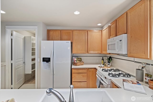 2801 1st Ave Unit 501, Seattle, WA 98121 - kitchen with white appliances, light countertops, tasteful backsplash, recessed lighting, and light brown cabinetry