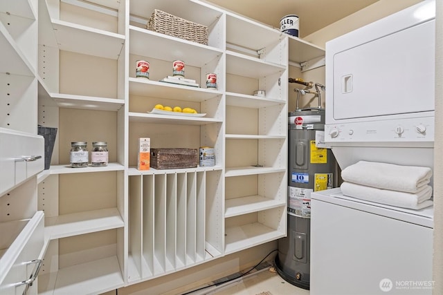 2801 1st Ave Unit 501, Seattle, WA 98121 - laundry area with stacked washer / drying machine and water heater