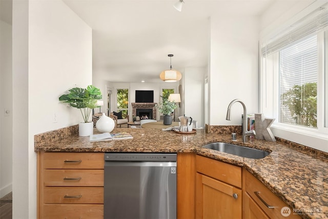 8615 238th St SW Unit B202, Edmonds, WA 98026 - kitchen featuring dishwasher, dark stone countertops, a warm lit fireplace, pendant lighting, and open floor plan
