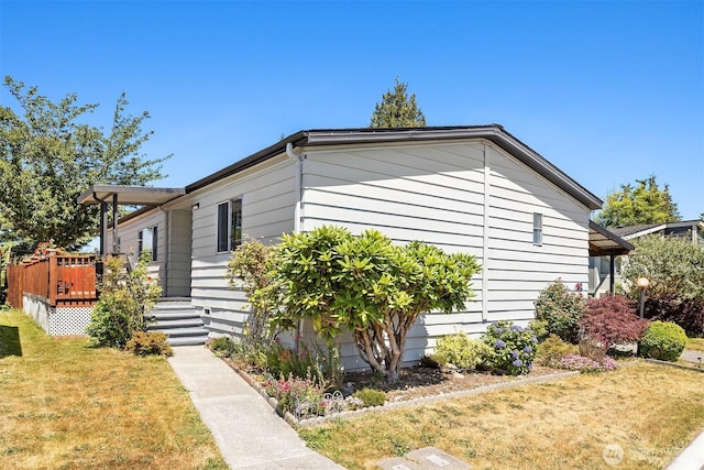 11500 Meridian Ave S Unit 22, Everett, WA 98208 - view of home's exterior featuring a wooden deck and a yard