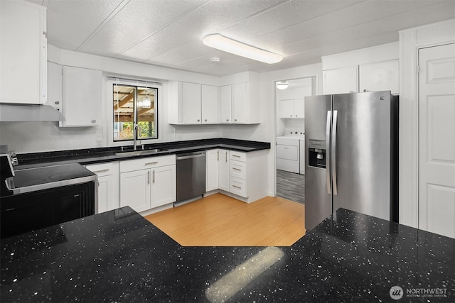11500 Meridian Ave S Unit 22, Everett, WA 98208 - kitchen with stainless steel appliances, washer / dryer, white cabinets, and dark stone countertops
