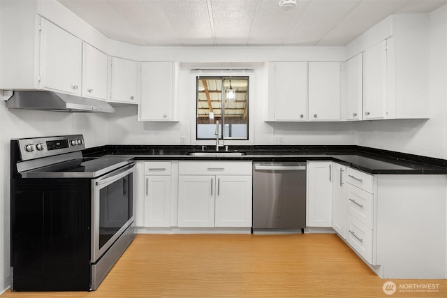 11500 Meridian Ave S Unit 22, Everett, WA 98208 - kitchen with stainless steel appliances, white cabinetry, under cabinet range hood, and dark countertops