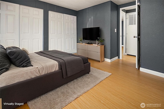 11500 Meridian Ave S Unit 22, Everett, WA 98208 - bedroom featuring wood finished floors and multiple closets