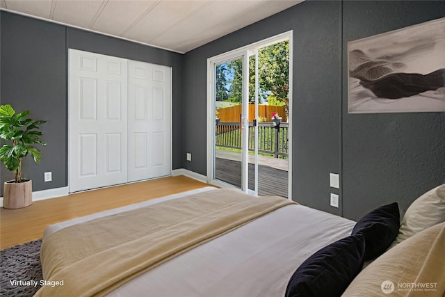 11500 Meridian Ave S Unit 22, Everett, WA 98208 - bedroom with access to exterior, wood finished floors, a textured wall, and a closet
