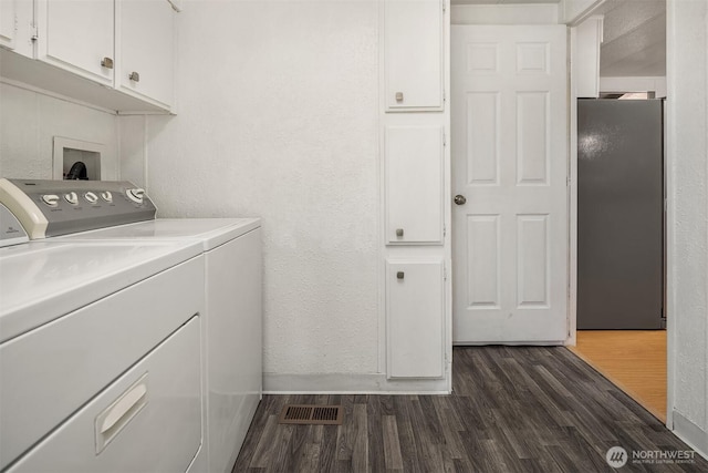 11500 Meridian Ave S Unit 22, Everett, WA 98208 - washroom featuring cabinet space, washing machine and clothes dryer, dark wood finished floors, and a textured wall