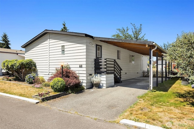 11500 Meridian Ave S Unit 22, Everett, WA 98208 - view of side of home featuring an attached carport and asphalt driveway