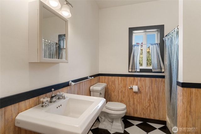 3613 Mcmullan Rd, Wenatchee, WA 98801 - bathroom featuring a wainscoted wall, tile patterned floors, wood walls, and a shower with shower curtain