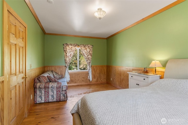 3613 Mcmullan Rd, Wenatchee, WA 98801 - bedroom featuring a wainscoted wall, wood finished floors, wood walls, and ornamental molding
