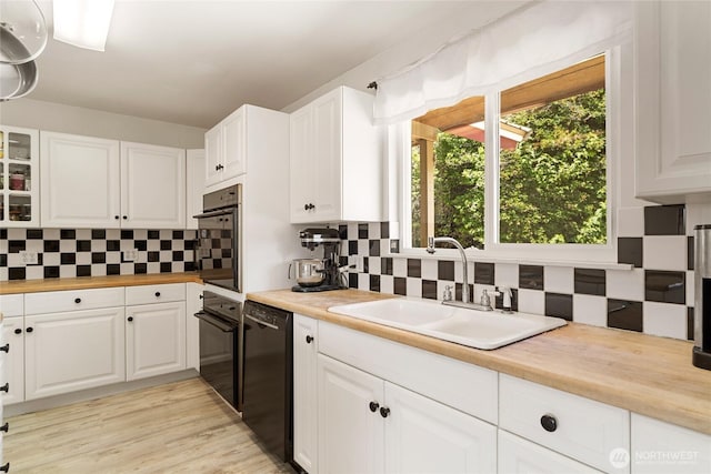 3613 Mcmullan Rd, Wenatchee, WA 98801 - kitchen with black appliances, wood counters, backsplash, and white cabinets