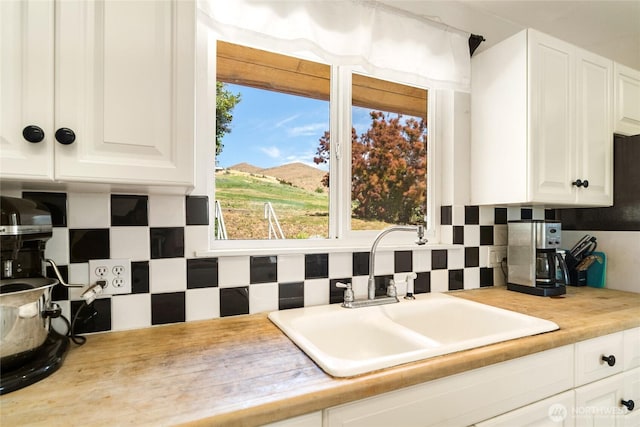 3613 Mcmullan Rd, Wenatchee, WA 98801 - kitchen featuring backsplash, white cabinets, and light countertops