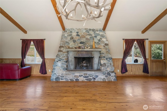 3613 Mcmullan Rd, Wenatchee, WA 98801 - living area with wainscoting, wood finished floors, a chandelier, and a stone fireplace