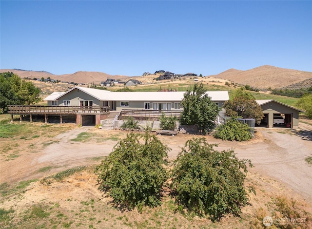 3613 Mcmullan Rd, Wenatchee, WA 98801 - view of front facade with stairs, dirt driveway, a deck with mountain view, and a detached garage