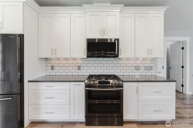 3761 Hannah Ct, Bellingham, WA 98226 - kitchen featuring stainless steel appliances, dark countertops, and white cabinetry