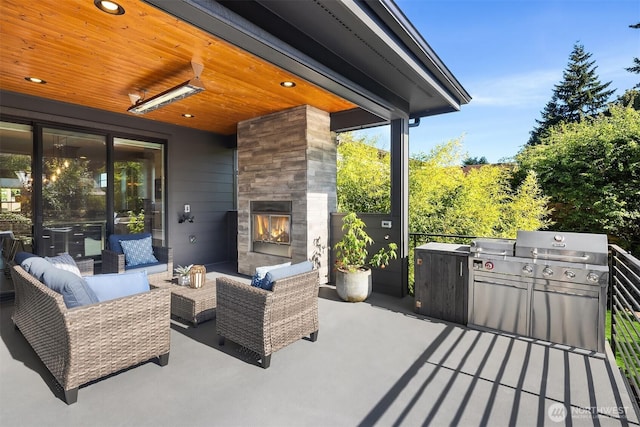 8841 Dibble Ave NW, Seattle, WA 98117 - view of patio with an outdoor living space with a fireplace and exterior kitchen