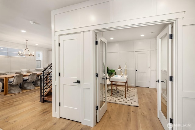 8841 Dibble Ave NW, Seattle, WA 98117 - hall featuring light wood finished floors, a chandelier, and recessed lighting