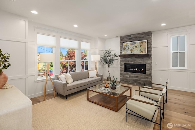 8841 Dibble Ave NW, Seattle, WA 98117 - living room with light wood finished floors, a tile fireplace, a decorative wall, and recessed lighting