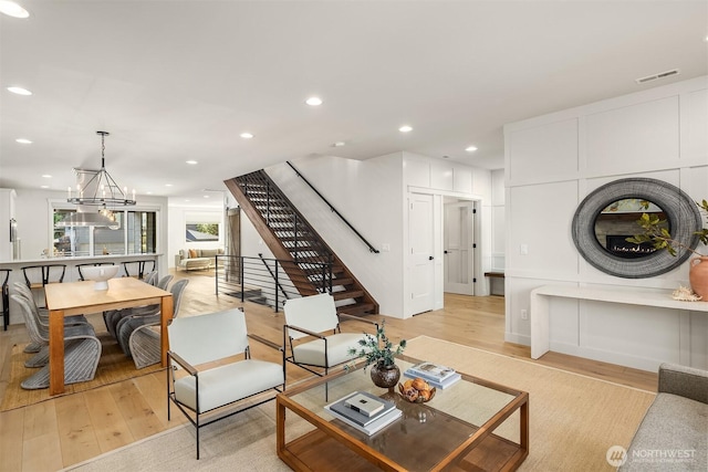8841 Dibble Ave NW, Seattle, WA 98117 - living area featuring light wood-style floors, stairway, recessed lighting, and a chandelier