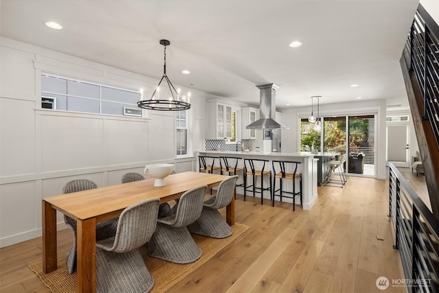 8841 Dibble Ave NW, Seattle, WA 98117 - dining room featuring recessed lighting, light wood-type flooring, and a chandelier