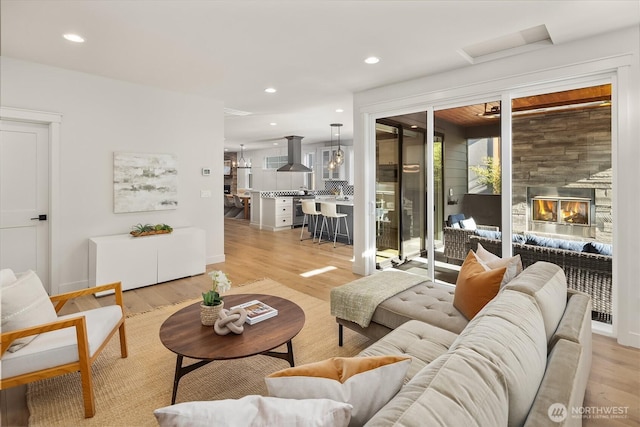 8841 Dibble Ave NW, Seattle, WA 98117 - living area with light wood-style flooring, a glass covered fireplace, and recessed lighting