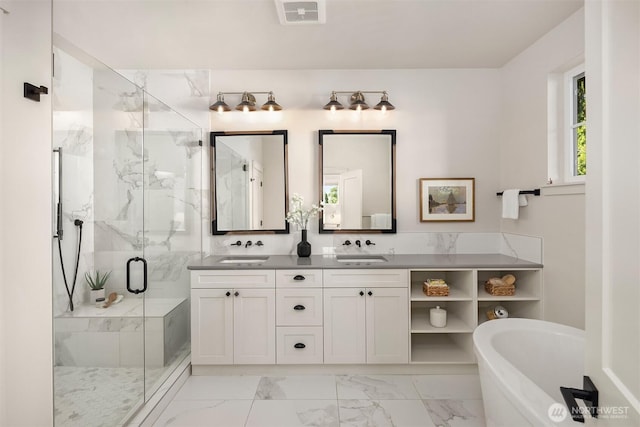 8841 Dibble Ave NW, Seattle, WA 98117 - full bathroom with marble finish flooring, double vanity, a freestanding tub, and a marble finish shower