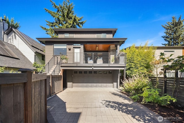 8841 Dibble Ave NW, Seattle, WA 98117 - modern home featuring a balcony, a garage, and decorative driveway