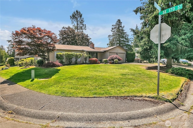 17004 137th Pl SE, Renton, WA 98058 - ranch-style home with an attached garage, a front yard, a chimney, and driveway