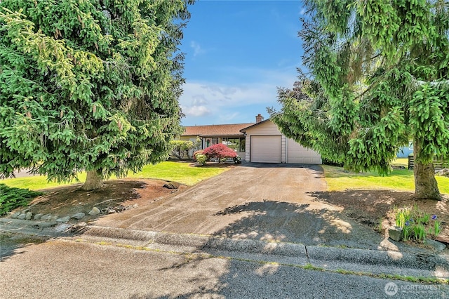 17004 137th Pl SE, Renton, WA 98058 - view of front of home with driveway, an attached garage, and a front yard