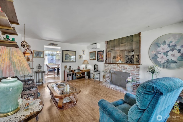 17004 137th Pl SE, Renton, WA 98058 - living area featuring a wall unit AC, wood finished floors, and a fireplace