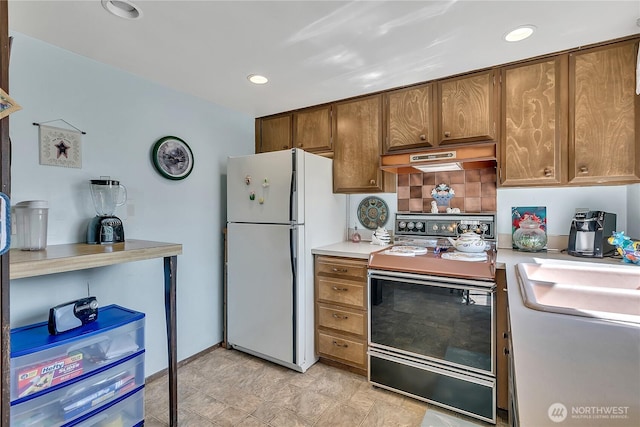 17004 137th Pl SE, Renton, WA 98058 - kitchen featuring freestanding refrigerator, electric range, light countertops, custom range hood, and decorative backsplash