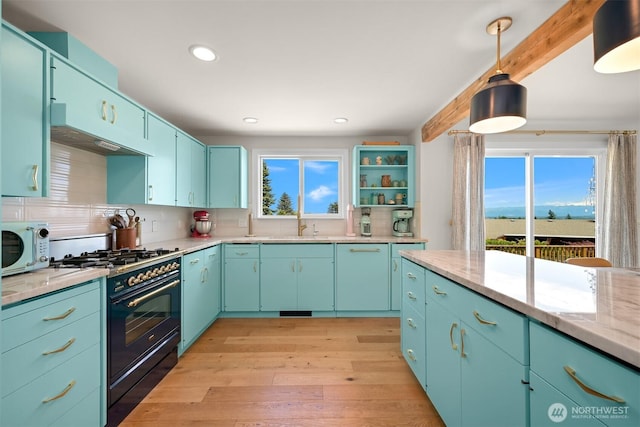 6002 Ridgeview Pl, Ferndale, WA 98248 - kitchen featuring black gas range, white microwave, light wood-style floors, recessed lighting, and pendant lighting