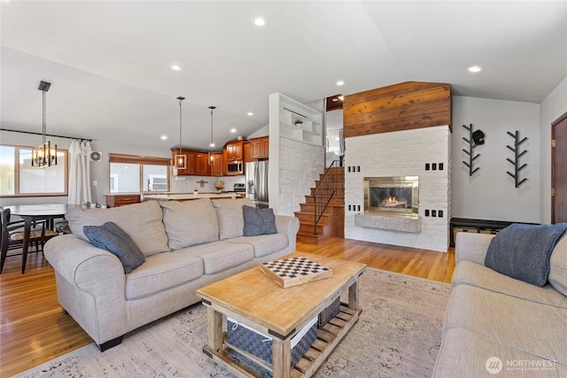922 SW 160th St, Burien, WA 98166 - living room with vaulted ceiling, light wood finished floors, a fireplace, a chandelier, and recessed lighting